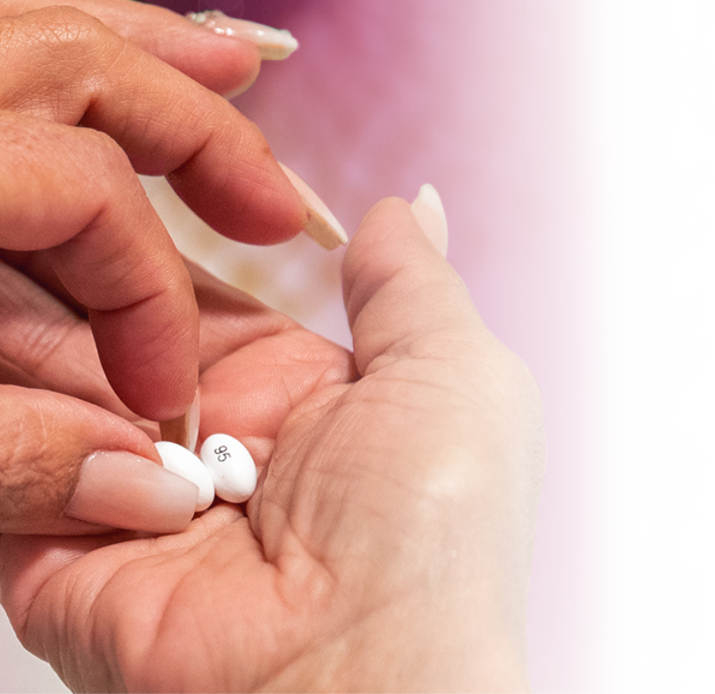 Patient holding BAFIERTAM (monomethyl fumarate) soft gel capsules.